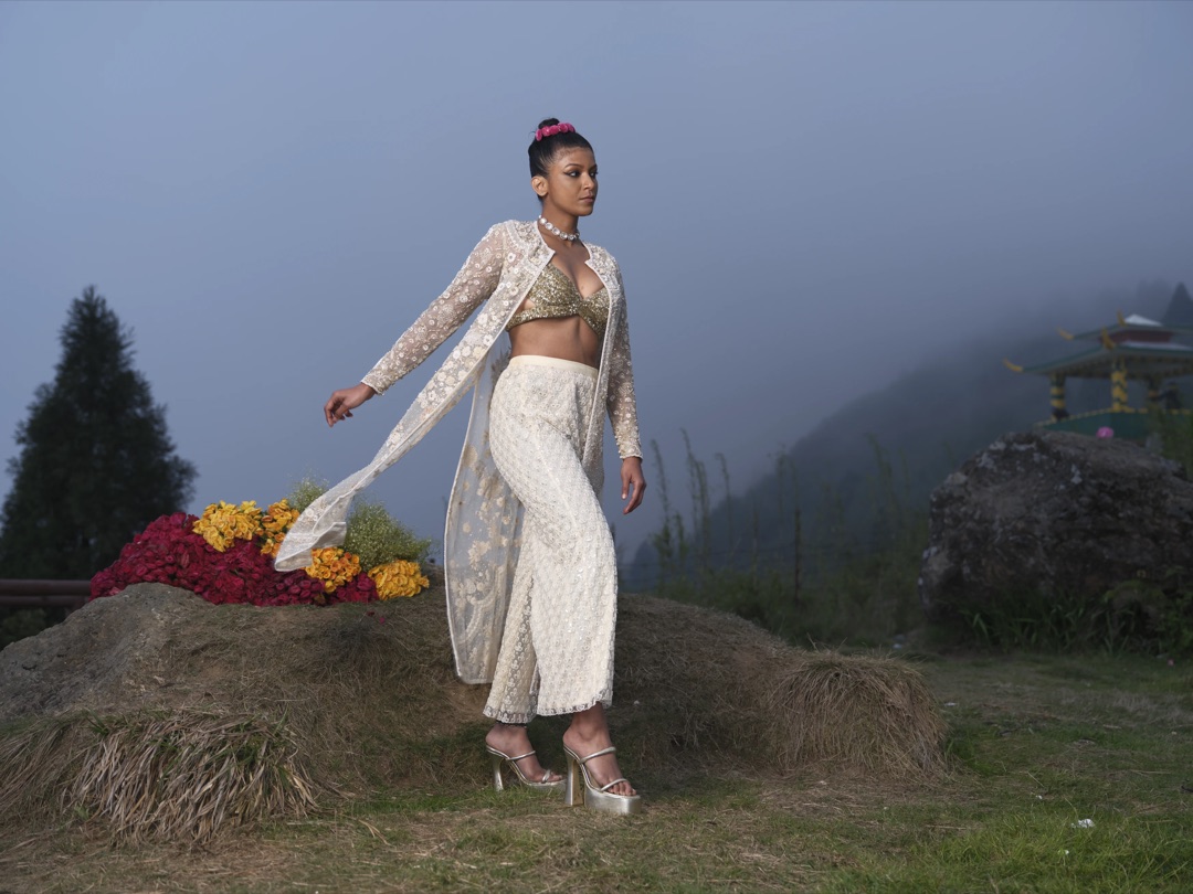 Ivory hand-embroidered couture on a Himalayan hillside, valley mist below